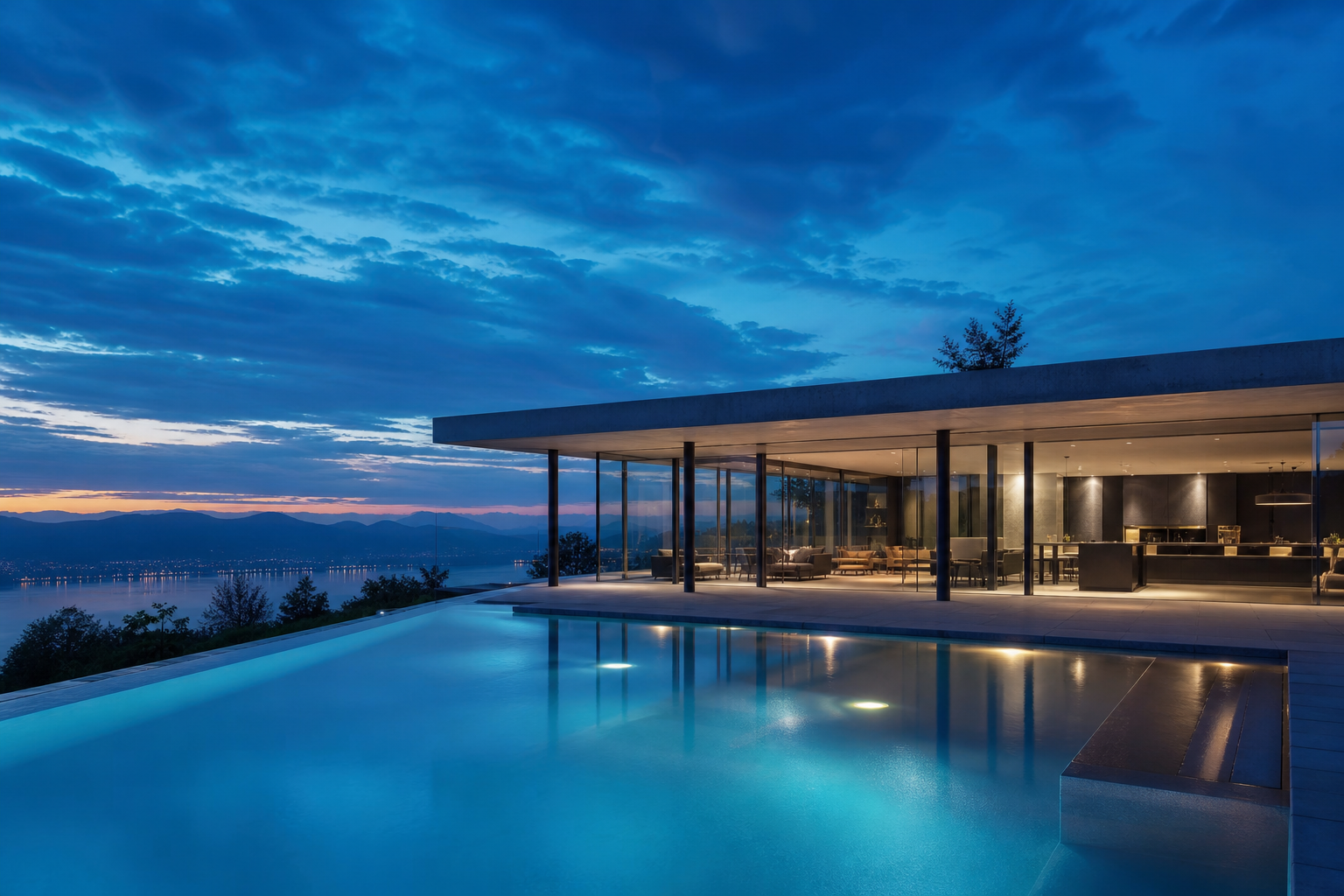 Exterior of a completed Lumen house at blue hour, its glazed living room glowing above a still lap pool.